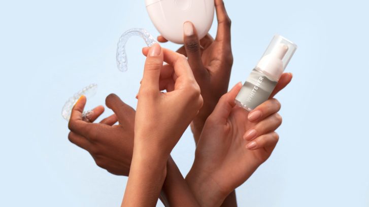 two sets of hands holding professional whitening products, such as gel and trays