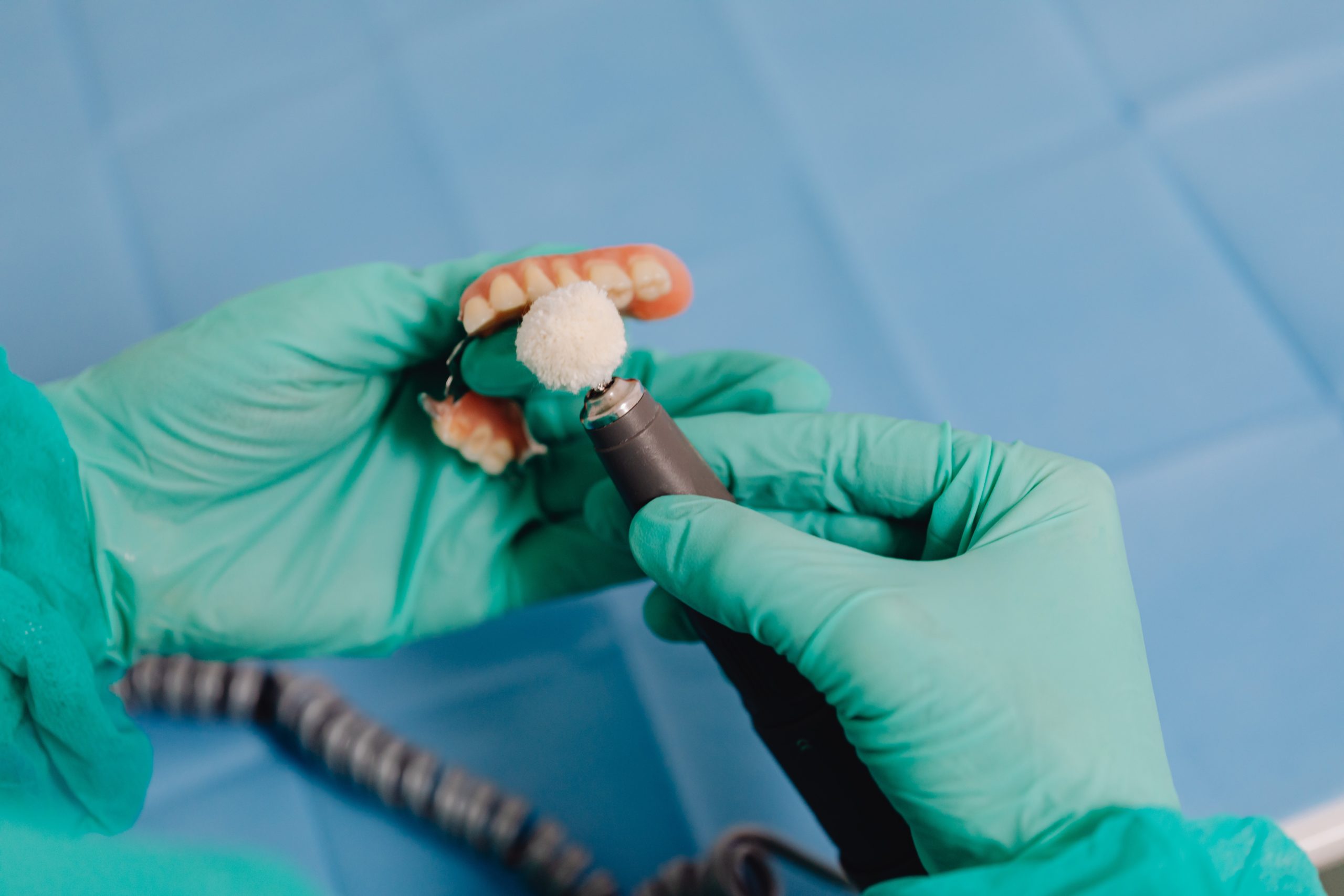 dentist holding a dental bridge